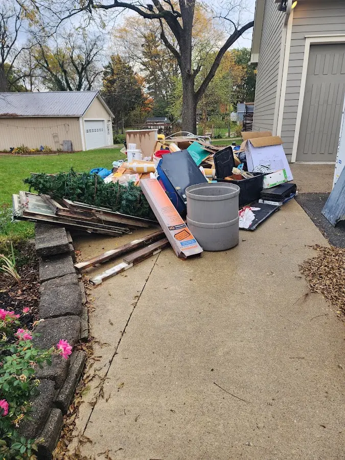 Dumpster being loaded with debris for Estate Cleanout Dumpster Rental in Chisago City